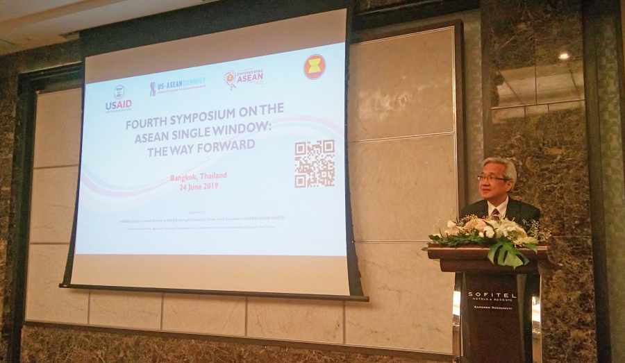 Man speaks at podium with "SOFITEL" logo in front of a screen reading "ASEAN SINGLE WINDOW".